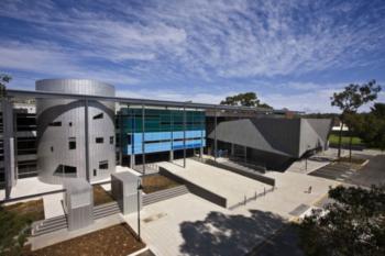 modern campus buildings under blue skies with clouds