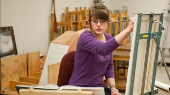 student working on a loom