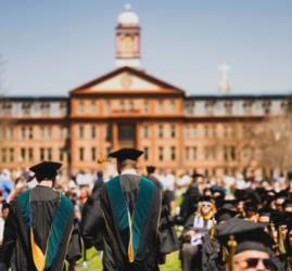 Regis University commencement with campus building and students