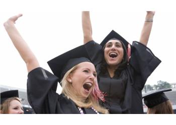 excited graduates in caps celebrating