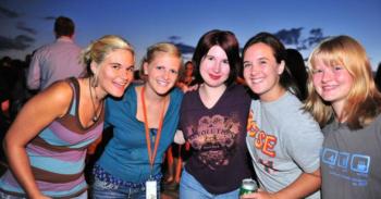 group of five women smiling outdoors