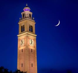 clock tower at dusk with crescent moon