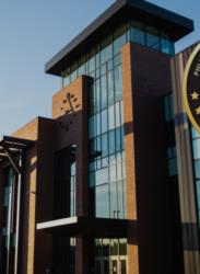 modern university building with seal and clear sky