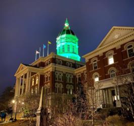 illuminated building with green-lit dome at night