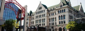 historic building with green roofs and a modern glass structure