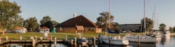 sailboats docked near campus buildings