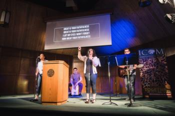 chapel service with singers and projected text