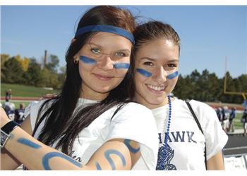 two students with face paint at a sports event