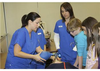 nursing students practicing with medical equipment