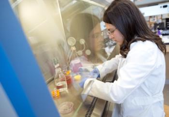 student conducting research in a lab with protective gear