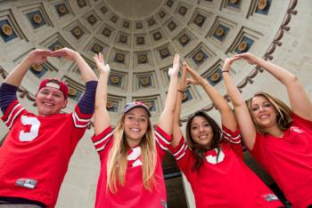 students forming o-h-i-o under ornate dome
