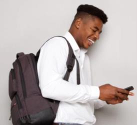 smiling student with backpack looking at phone