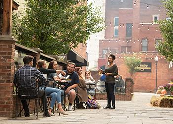 students socializing at an outdoor café area