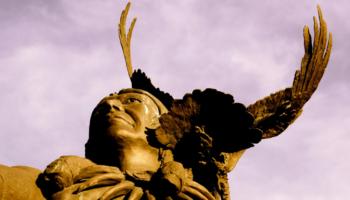 statue of a native american with eagle wings