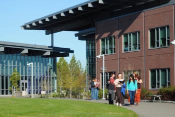 students walking near modern campus buildings