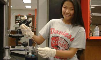 student in lab with equipment