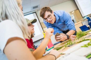 student learning botanical samples with instructor