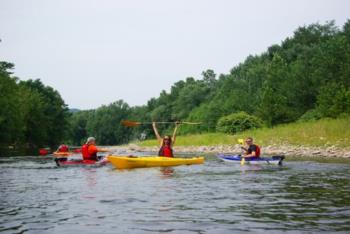 group kayaking on a river