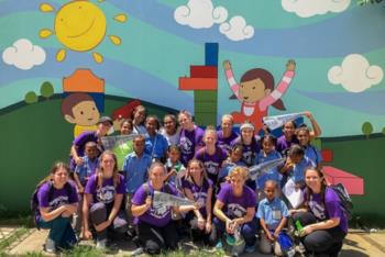 group photo with colorful mural background