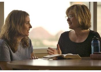 two women in discussion at school