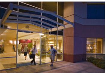 people entering campus building at night