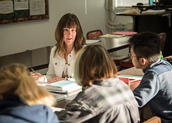 instructor discussing with students in a classroom